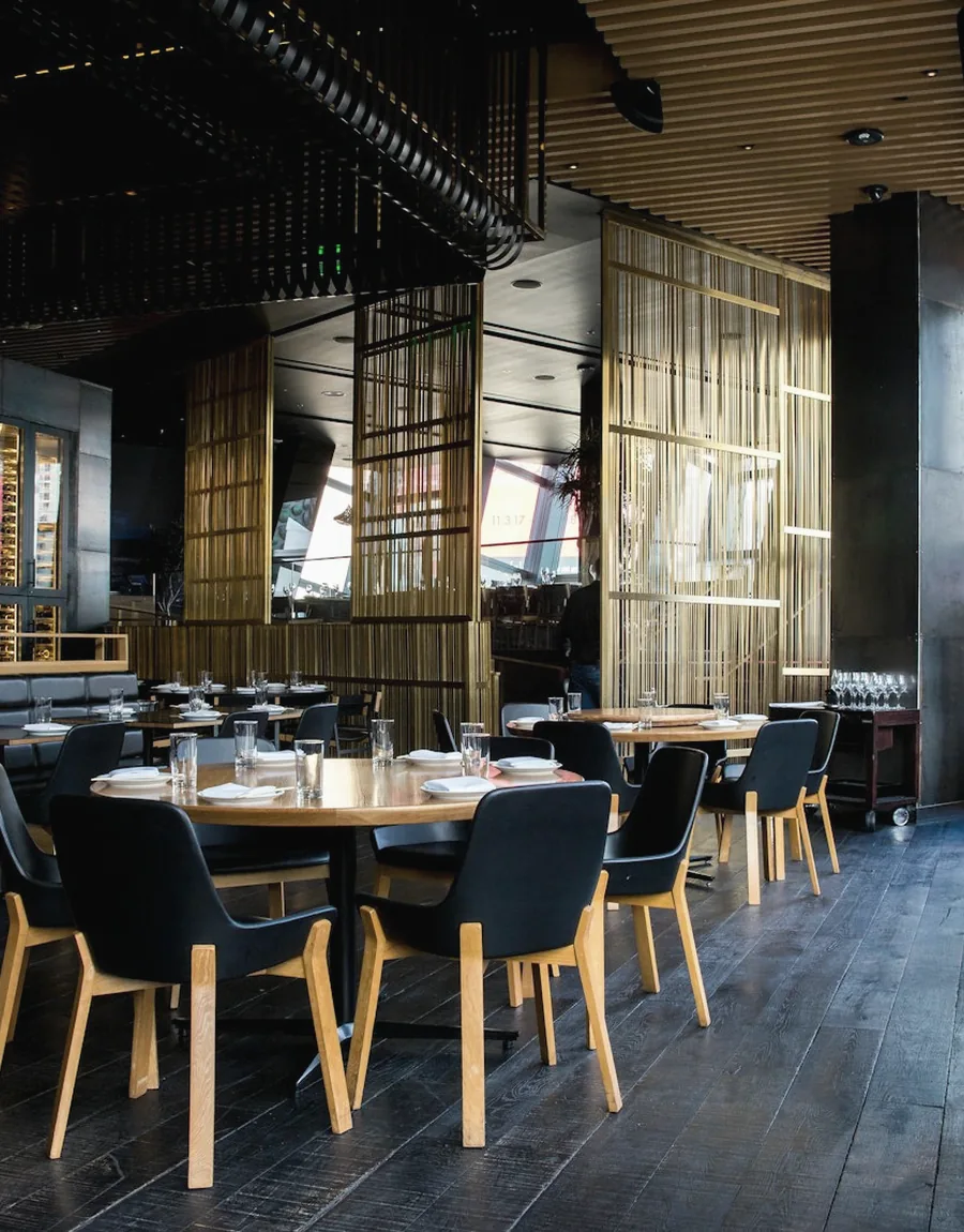 Large venue interior with bar seating and warm lighting
