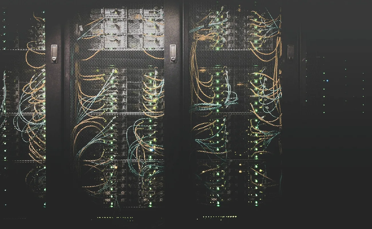 Dark equipment racks with patched network cabling in a server room